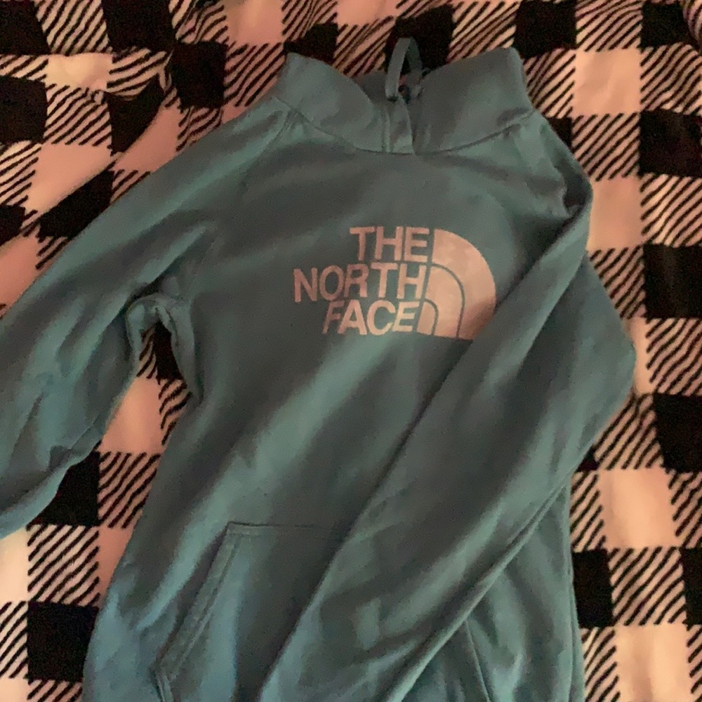 Blue North Face hoodie. With grey writing.